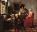 Una dama bebiendo y un caballero barroco Johannes Vermeer